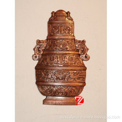 bronze modern relief sculpture with vase